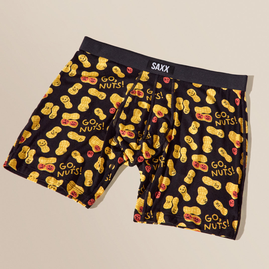 Black boxer briefs with yellow peanut design and 'GO NUTS!' text, featuring the SAXX brand.