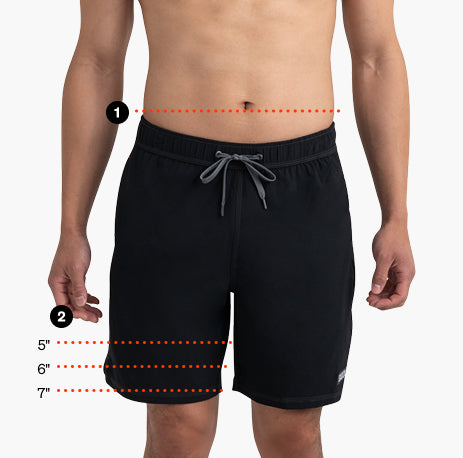 Front view of a model wearing black SAXX swim shorts with measurement guides showing waistband position and inseam length options of 5, 6, and 7 inches.