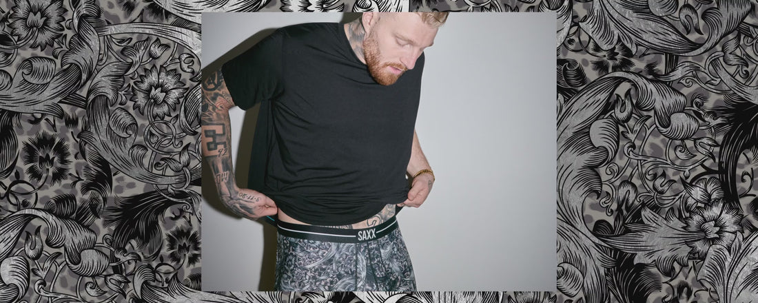A video of multiple images of a man wearing patterned underwear against a backdrop in the same floral-inspired print.
