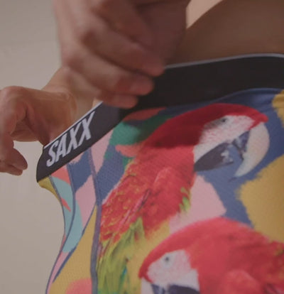 Man wearing boxer briefs in colorful parrot print