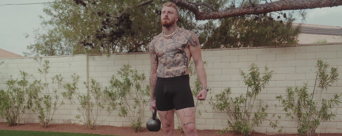 Maxx Crosby wears SAXX Underwear as he exercises in an outdoor gym.