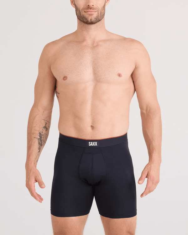 Man wearing black SAXX underwear on a plain background