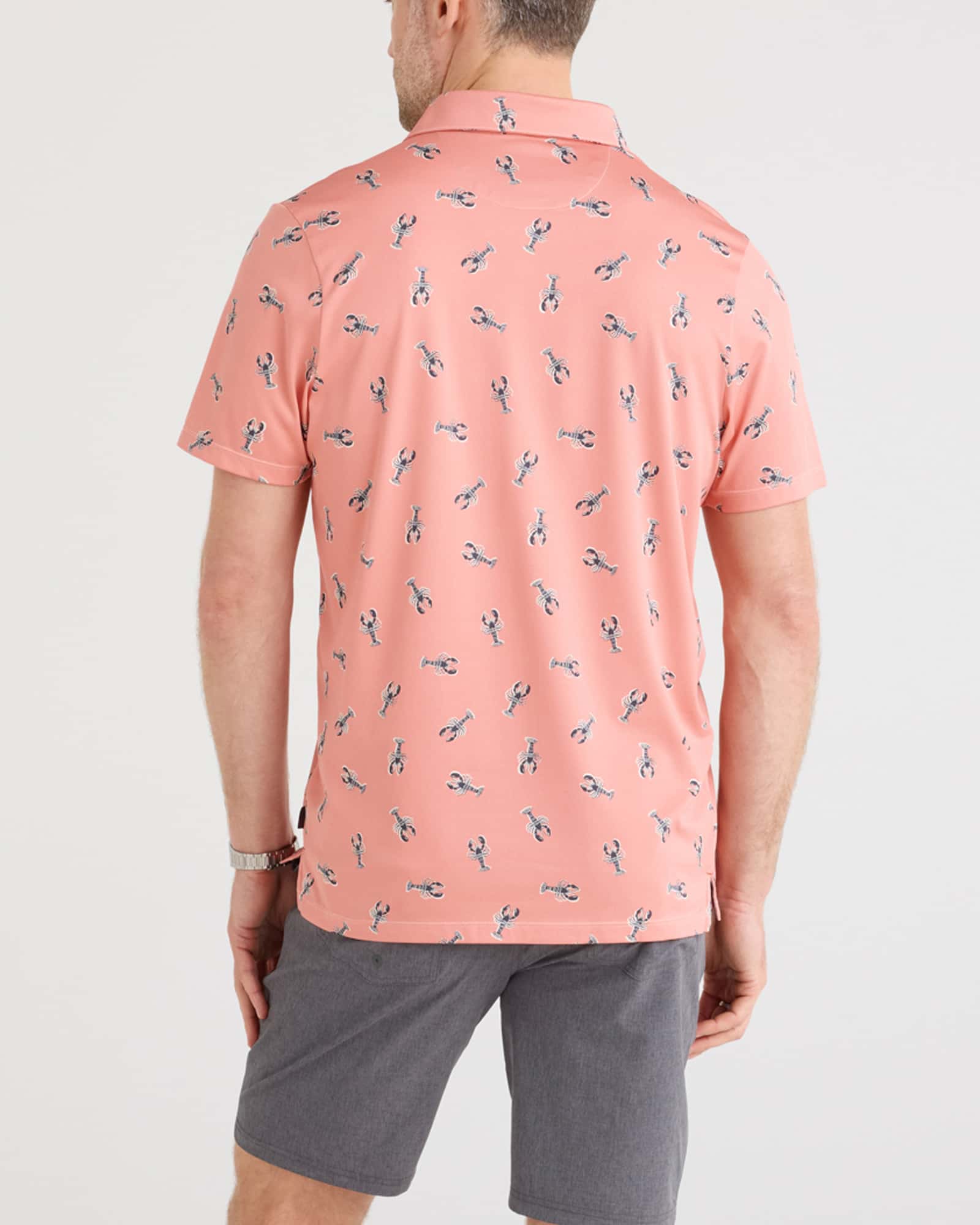 Back - Model wearing Droptemp Dry Polo in Lobster Boil-Burnt Coral