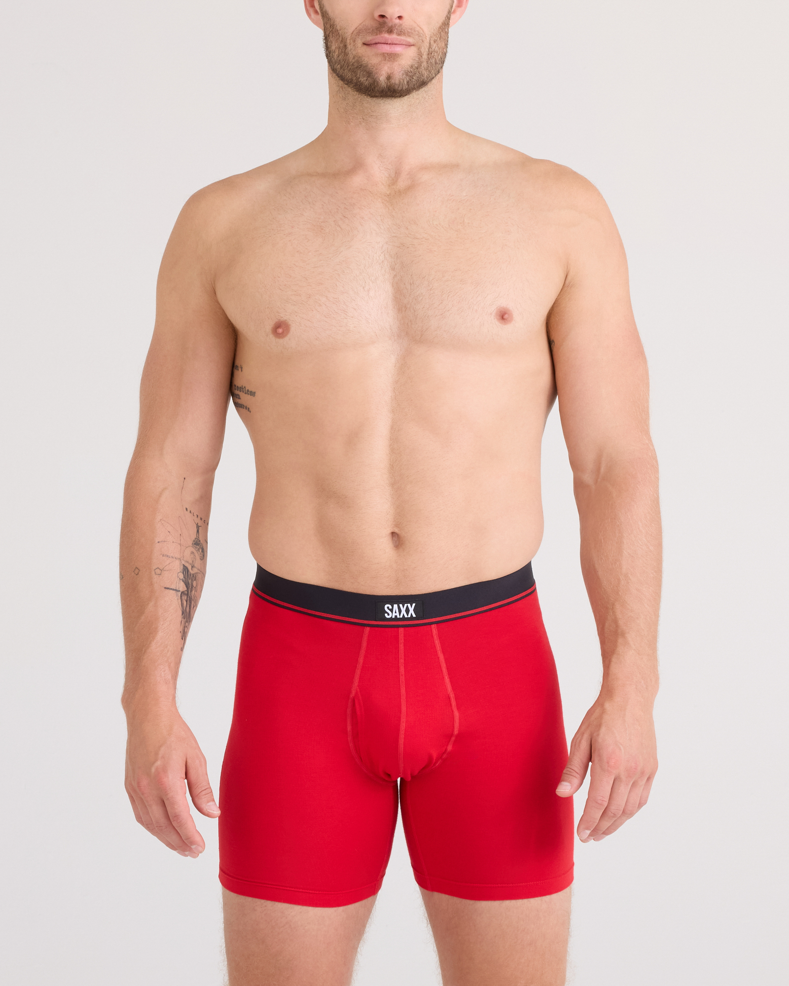 Front - Model posing in Essential Cotton Boxer Brief in Classic Red
