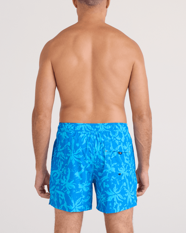 Back - Model wearing  Oh Buoy 2N1 Swim Trunk 5" in Splash Palms-Bold Blue