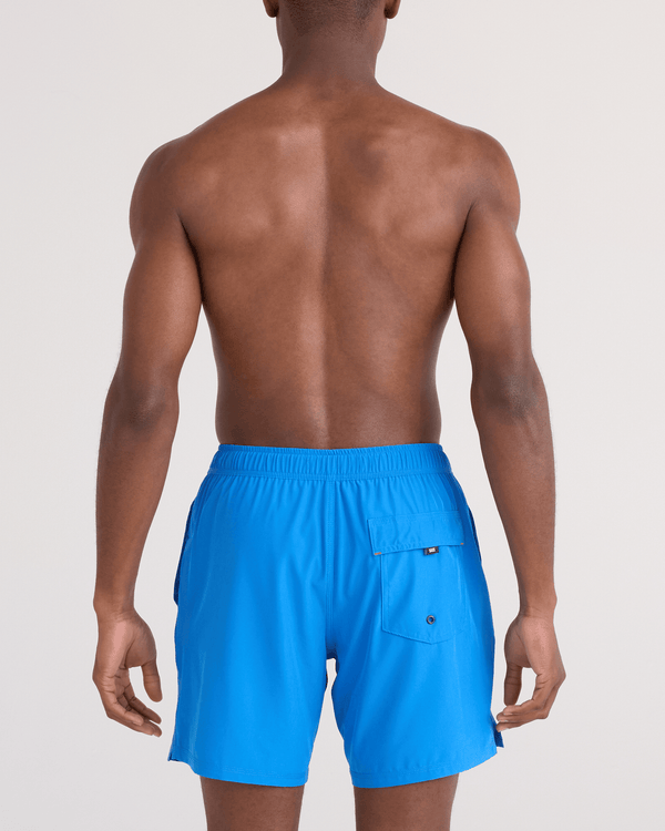 Back - Model wearing  Oh Buoy 2N1 Swim Trunk 7" in Bold Blue