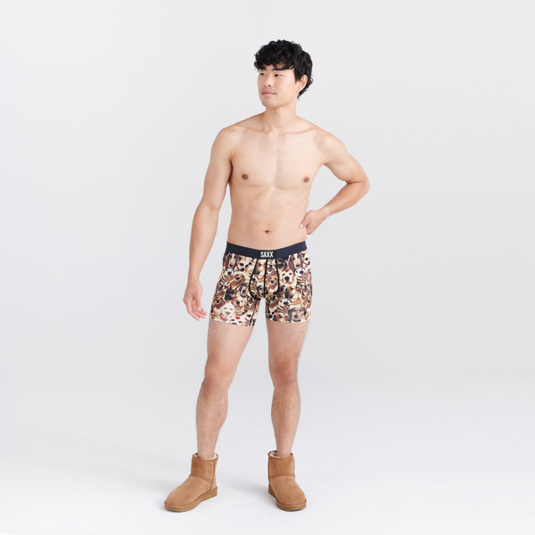 Front - Model wearing Vibe Super Soft Boxer Brief in Dogs Of Saxx- Multi