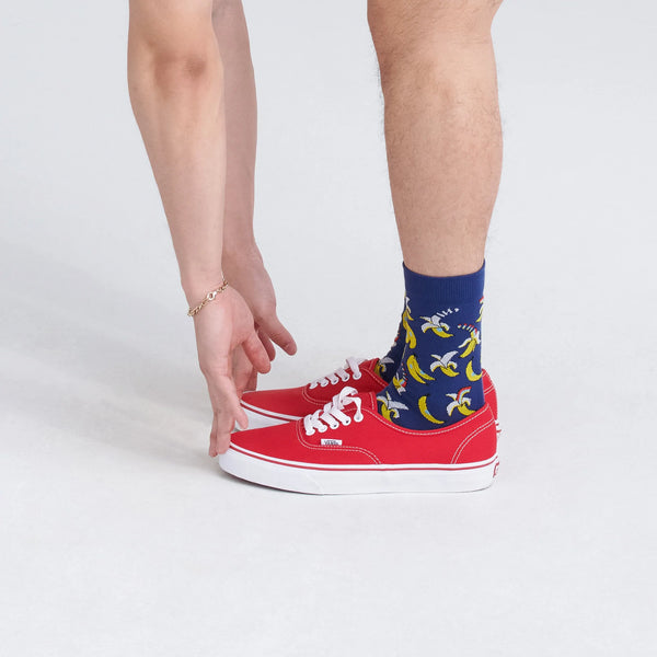 Front - Model wearing Whole Package Crew Sock in Rainbow Banana- Navy