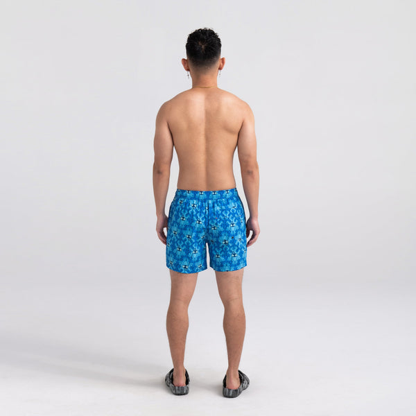 Back - Model wearing Oh Buoy 2N1 Swim Short Trunk in Krakken Toile- Blue