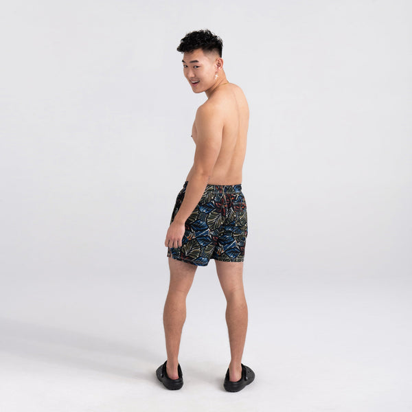 Back - Model wearing Oh Buoy 2N1 Swim Short Trunk in Painterly Paradise- Multi