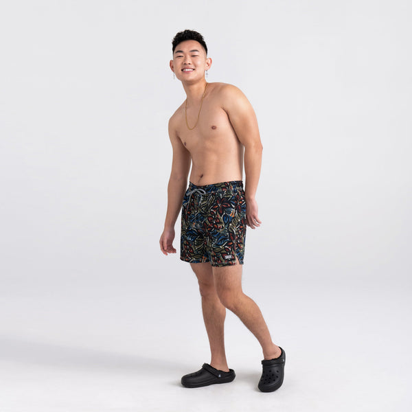 Front - Model wearing Oh Buoy 2N1 Swim Short Trunk in Painterly Paradise- Multi
