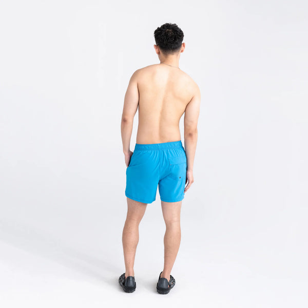 Back - Model wearing Oh Buoy 2N1 Swim Volley Short 5" in Tropical Blue