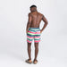 Back - Model wearing Oh Buoy 2N1 Swim Volley Short 7" in Cutback Stripe- Brt Multi
