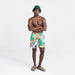 Front - Model wearing Oh Buoy 2N1 Swim Volley Short 7" in Island Patchwork- Multi